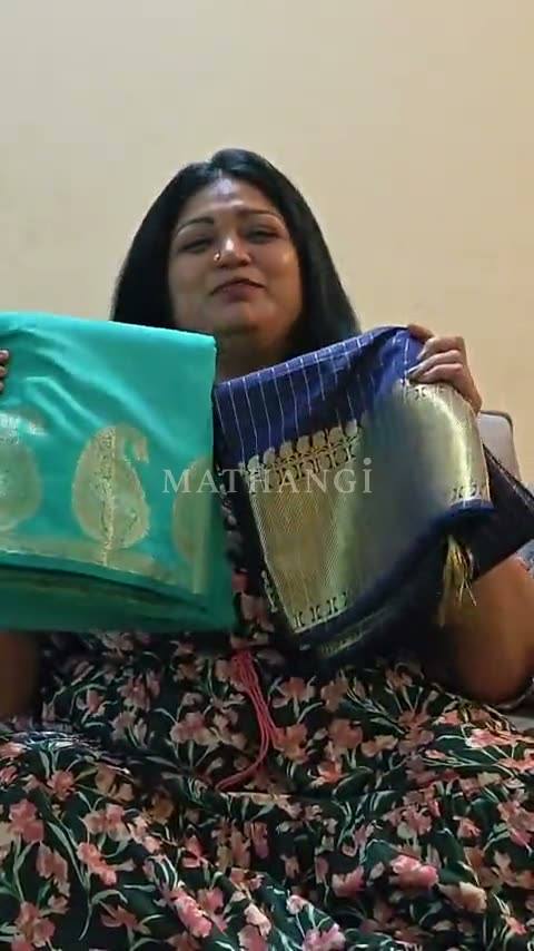 The teal and the navy saree held up together