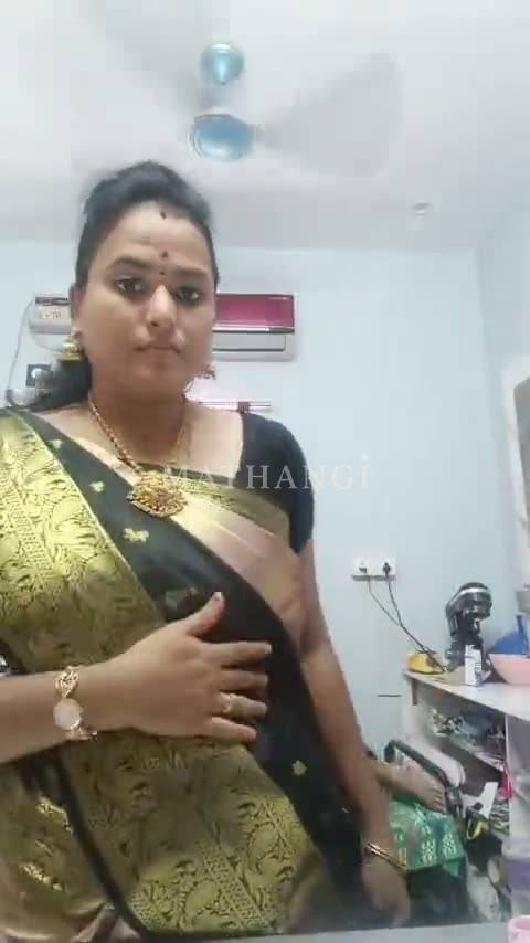 A black saree with gold buttas and a broad gold border carried across the shoulder