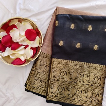 Black Kanchipuram silk saree with a broad gold zari border